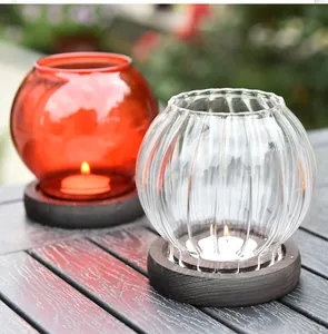 Detailed view of elegant colored glass candle holders with dark wooden bases