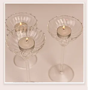 Detailed macro view of elegant ribbed glass candlesticks with lit tea light candles