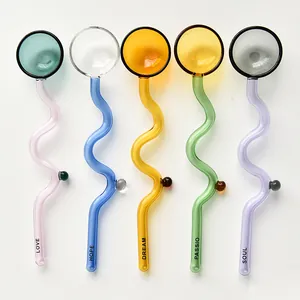 Macro view of colorful wavy glass stirrers with inspirational words LOVE and DREAM