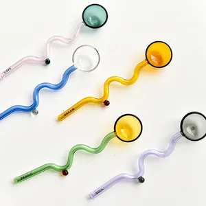 Close-up of colorful heat-resistant glass stirrers with wavy handles and round heads