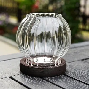 Elegant vintage ribbed glass candle holder with dark wooden base for windproof decor