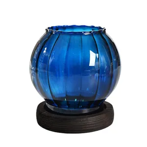 Elegant cobalt blue ribbed glass candle holder with dark wood base for home decor