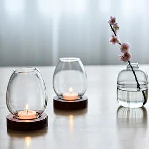 Elegant Zen style transparent glass candle holders with wooden bases and plum blossoms