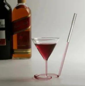 Close-up of creative spiral cocktail glass with integrated straw and red wine detail