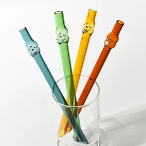 Detailed macro view of cute animal shaped colored glass straws for juice or tea