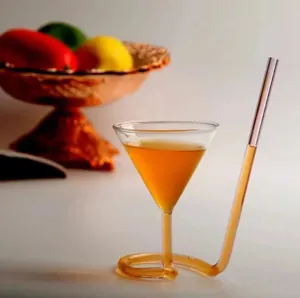Creative spiral straw cocktail glass with a unique twisted stem and amber drink.