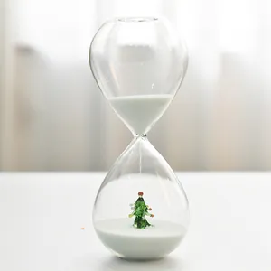 Creative glass Christmas hourglass timer featuring a miniature tree and fine white sand