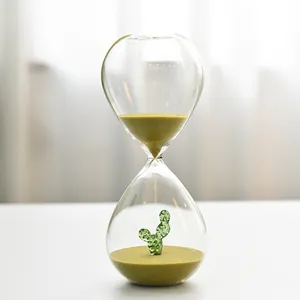 Elegant creative glass hourglass timer featuring internal cactus and olive sand