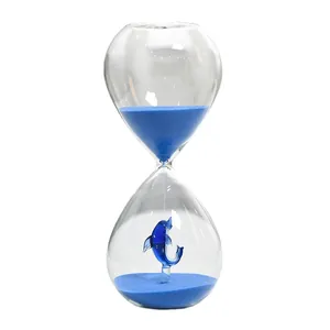 Creative 30-minute glass hourglass with blue sand and decorative dolphin sculpture