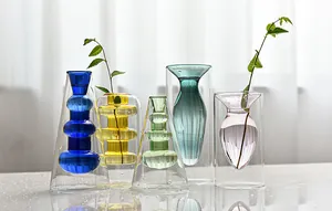 Detailed shot of various Nordic style double-layered colorful glass vases for hydroponics