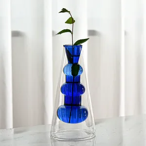 Detail of a Nordic double-layered blue and clear glass vase for minimalist decor