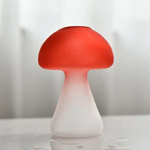 Detail view of a creative mushroom-shaped glass vase with red-to-white frosted gradient.