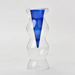 Detailed view of Nordic double-layer glass vase with blue cone and wavy clear outer.