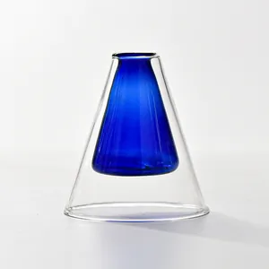Detailed close-up view of a cone-shaped double-walled glass vase with blue inner core