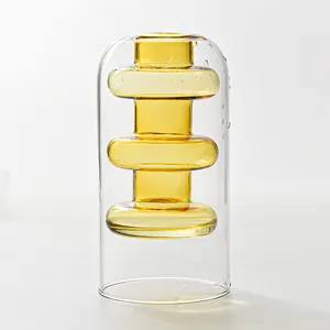 Macro detail of a modern double-layer glass vase featuring an amber stacked bead inner core.