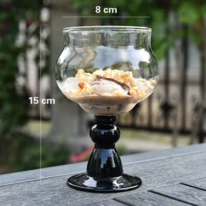 Detailed view of an elegant glass ice cream bowl with black stem and 15cm height
