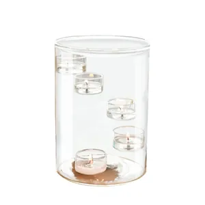 Large clear glass cylinder candle holder with spiral tiered tea light cups for dinner.