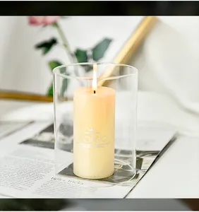 Close-up detail view of a smokeless pillar candle inside a clear glass cylinder vase