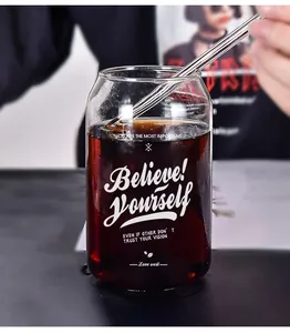 Detail of can-shaped glass cup with Believe! Yourself print and glass straw.