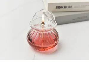 Exquisite close-up of a vintage handmade glass oil lamp with a lit flame and pink fuel