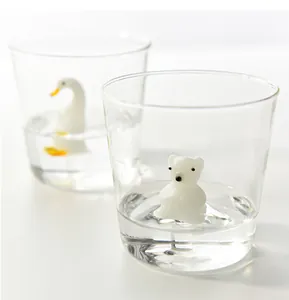 Detailed shot of creative glass cup with internal 3D polar bear and duck figures