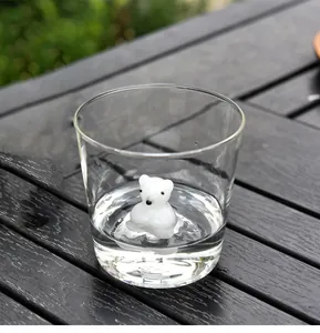 Detailed view of a cute 3D white polar bear figurine at the bottom of a clear glass cup
