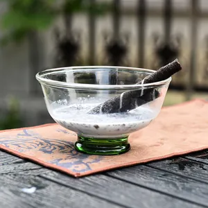 Minimalist glass ice cream bowl with vintage green pedestal base for elegant dessert