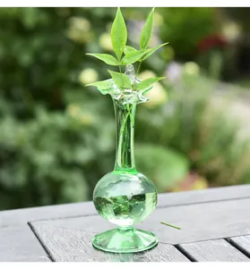 Detailed view of a vintage green transparent glass bud vase with elegant wavy petal rim