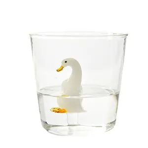 Creative 3D white duck figurine inside a clear glass water and juice cup for home use.