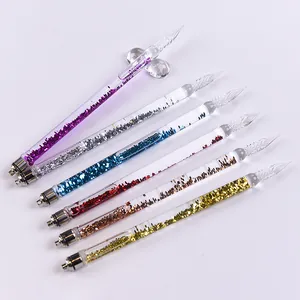 Detail view of six colorful glitter-filled glass dip pens on a white background