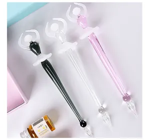 Elegant ballerina glass dip pen set with three artistic pens in black, white, and pink.