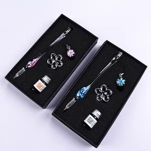 Luminous glass dip pen gift set with floral design, pen rest, and ink in elegant black box.