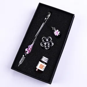 Elegant glass dip pen set with flower design, including ink bottle and flower pen rest.