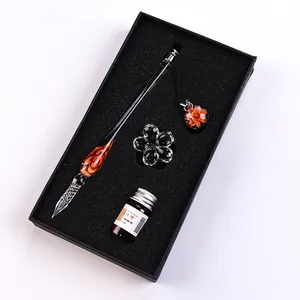 Detailed view of glass dip pen gift set including 5ml ink bottle and floral accessories