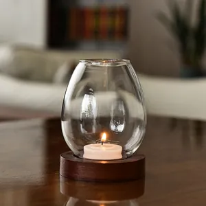 Elegant clear glass candle holder with wooden base for romantic candlelight dinner
