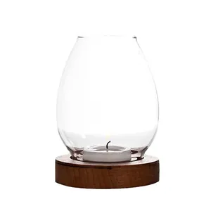 Minimalist transparent glass hurricane candle holder with rustic wooden base for tea lights