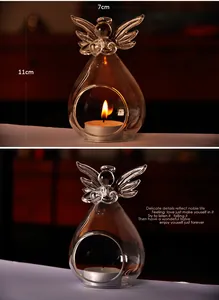 Detailed view of European clear glass angel candle holder with a warm flickering tealight