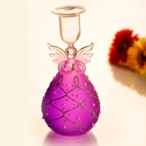 Detailed view of a purple glass angel candle holder with glitter and pearls decoration.