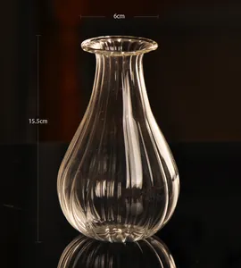 Close-up detail of transparent ribbed glass vase showing 15.5cm height and 6cm opening size
