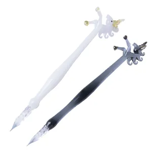 Exquisite handmade glass dip pens featuring unique unicorn toppers in black and white