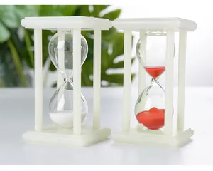Macro view of white and red sand hourglasses with luminous frames on a white surface