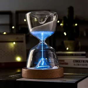 15-minute luminous glass hourglass timer with glowing blue sand and wooden base