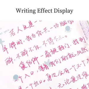 Colorful glass dip pen set showing vibrant pink ink writing effect on artistic paper