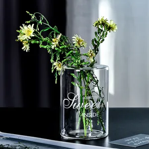 Creative transparent cylindrical glass vase featuring artistic 'Something Sweet Inside' text
