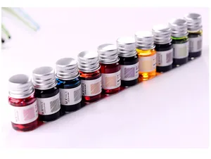 Close-up of vibrant non-carbon colorful fountain pen ink in small glass bottles