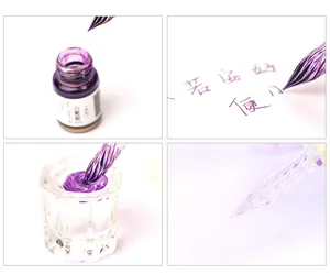 Close-up detail of a professional glass dip pen with purple shimmer ink and inkwell