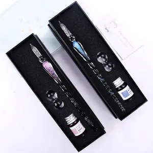 Detail view of handmade starry sky glass dip pen set including ink and pen rests in gift boxes