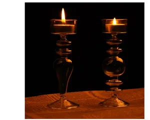 Elegant European style glass candle holders with lit tea lights for cozy home decor