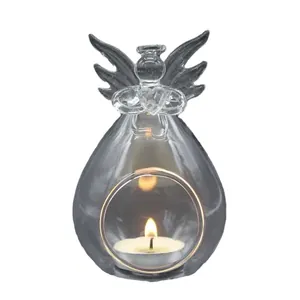 European style clear glass angel candle holder with lit tea light on white background