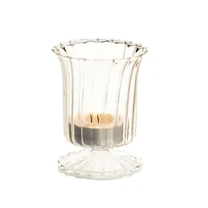 Elegant fluted clear glass candle holder with scalloped rim and pedestal base